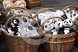 many soft toys in wicker baskets of panda, owl, monkey, camels,