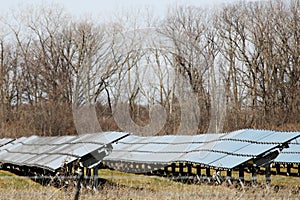 Many solar panels in a row in a large solar panel field