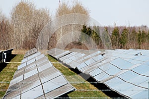 Many solar panels in a row in a large solar panel field