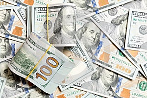 Many Stack of 100 dollar bills on dollars background top wiev with copy space