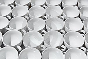 Many stacked in rows of empty clean white cups
