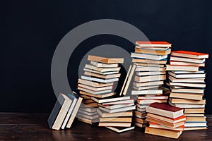 Many stacks of educational books to teach in the library on a black background