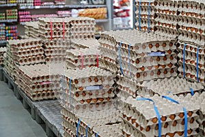 Many stacks of rows and paper packaging for chicken eggs, stacked in a store, brought from poultry farms in rural areas