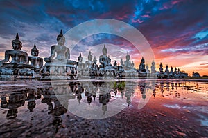 Many Statue buddha image at sunset in southen of Thailand photo