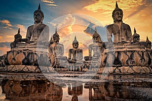 Many Statue buddha image at sunset in southen of Thailand photo