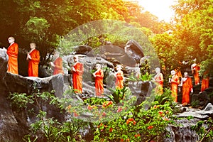 Many statues of Buddhist monks in the garden of Dambulla Cave Temple outside. Sri Lanka.