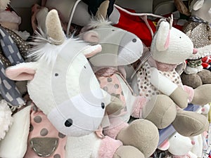Many stuffed toys on a shelf at christmas market fair in shopping mall