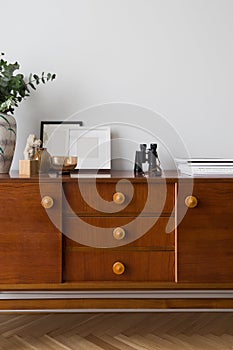 Many stylish decorations on retro style sideboard photo