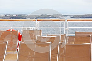 Many sun loungers are on deck of ship