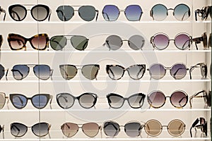 Many sunglasses on display in shop. Fashion Sunglasses in shop