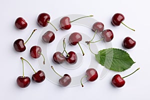 Many sweet ripe cherries on white background, flat lay