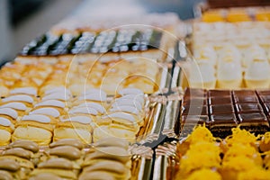 Many sweets prepared on the metal table of a food factory