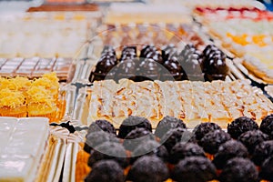 Many sweets prepared on the metal table of a food factory