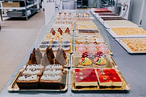 Many sweets prepared on the metal table of a food factory