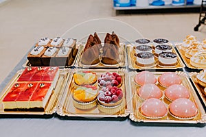 Many sweets prepared on the metal table of a food factory