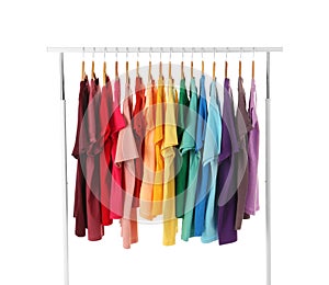 Many t-shirts hanging in order of rainbow colors