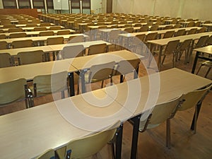 Many tables and chairs in the auditorium