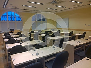 Many tables and chairs in the lecture room