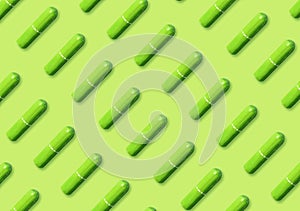 Many tampons on light green background, flat lay