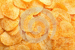 Many tasty crispy potato chips, top view