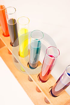 many test tubes filled with fluids of various colors