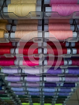 Many threads of different colors on plastic bobbins for sewing, for needlework.