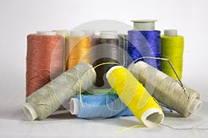 Many threads of different colors on a white background