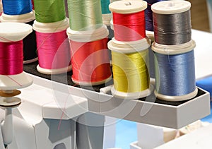 many threads of many colors for embroidery and sewing in the modern automatic sewing machine