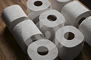 Many toilet paper rolls stacked in Tic-Tac-Toe toy form. Soft hygienic paper. Table made of black background