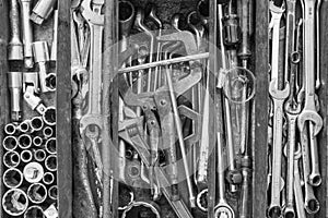 Many tools in rustic compartments toolbox. Technical machanic to