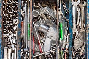 Many tools in rustic compartments toolbox. Technical machanic to