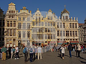 Many tourists in front of medieval guild houses in Brussels Gran Place square