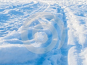 Many tracks and tire tracks in the snow