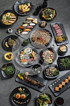many traditional japanese food dishes variety on grey background