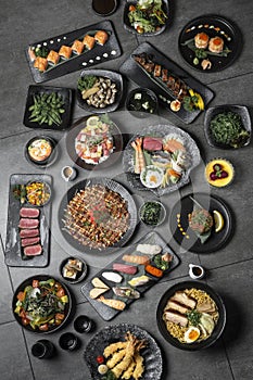 many traditional japanese food dishes variety on grey background