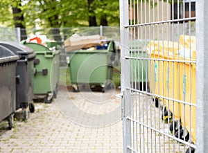 many trash can in row in city urban environment.basket full of garbage