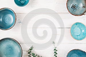 Many turquoise empty ceramic plates. Flat lay