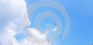 Many TVTelevision antenna on the blue sky and white clouds with above copy space