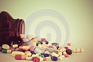 Many type of drugs poring from the bottle with isolation background photo