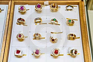 Many type gem ring jewely arrange on the golden plate in the display mirror box Jewely store