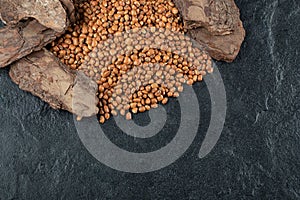 Many of uncooked brown kidney beans on a dark background