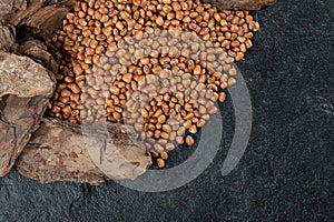 Many of uncooked brown kidney beans on a dark background