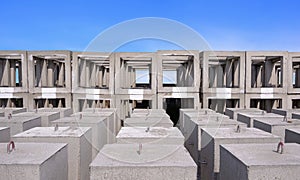 Many Underwater Concrete Anchors mooring buoys and Artificial Reef Blocks in industrial yard area against blue sky