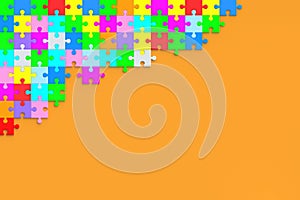 Many unfinished colorful puzzle jiggle pieces on orange background. Top view
