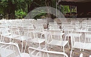 Many unoccupied outdoor chairs in front of stage i