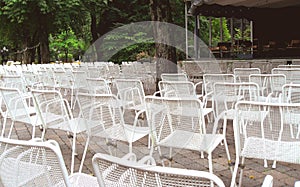 Many unoccupied outdoor chairs in front of stage i photo