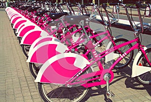 Many urban bicycles for rent are parked and waiting their customers in european city