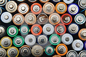 Many used batteries from different manufacturers. Old batteries for recycling