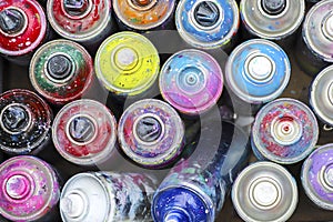 Many used cans of spray paint.