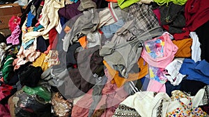 Many used clothes stacked together for donations